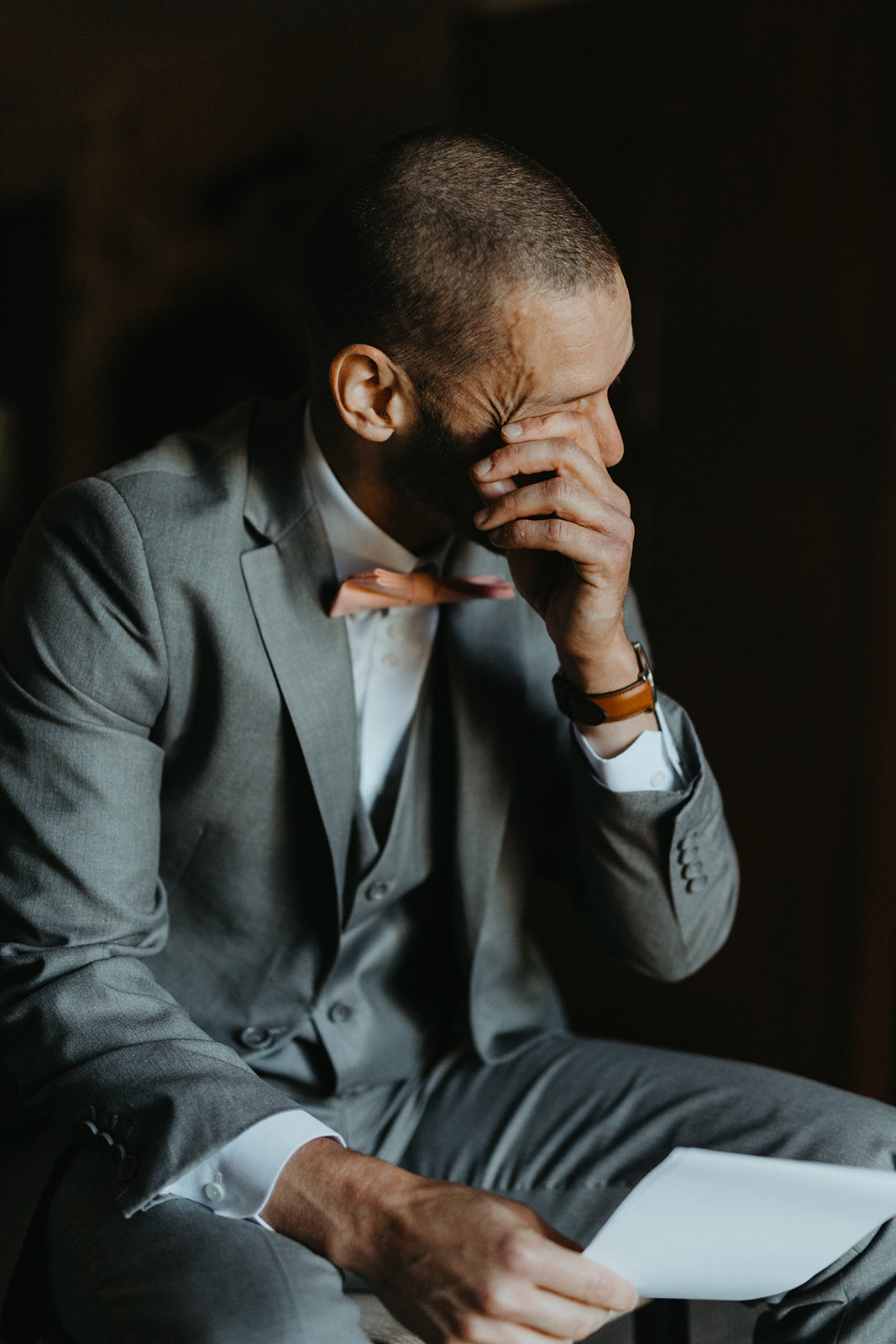 Emotional groom reading vows at an Emmanuelle Weddings event